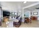 Bright and airy living room with wood floors, large windows, and seamless transition to the dining area at 6743 Wild Rose Ln, Evergreen, CO 80439