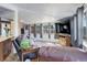 Comfortable living room showcasing wood floors, a leather sofa, and natural light from ample windows at 6743 Wild Rose Ln, Evergreen, CO 80439