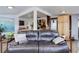 Inviting living room with open layout leading to kitchen, featuring comfortable seating and wood flooring at 6743 Wild Rose Ln, Evergreen, CO 80439
