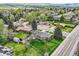 Neighborhood aerial view showcasing green lawns, mature trees, and a mix of single-Gathering homes at 798 Alkire St, Lakewood, CO 80401