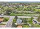 Aerial view of a neighborhood with green spaces, mature trees, and various residential homes at 798 Alkire St, Lakewood, CO 80401