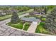 Aerial view of a home showcasing its well-maintained lawn, mature trees, and driveway at 798 Alkire St, Lakewood, CO 80401