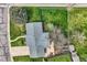 Aerial view of a landscaped backyard with green lawn, mature trees, and a patio at 798 Alkire St, Lakewood, CO 80401