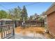 Cozy backyard patio area with gate, wood fence and mature trees at 798 Alkire St, Lakewood, CO 80401