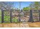 Backyard gate features artistic leaf design, with piles of debris visible beyond at 798 Alkire St, Lakewood, CO 80401