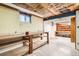 Unfinished basement with a workbench, offering a versatile space for hobbies or storage at 798 Alkire St, Lakewood, CO 80401