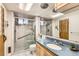Bright bathroom with a walk-in shower, single vanity and ample lighting at 798 Alkire St, Lakewood, CO 80401