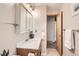 Inviting bathroom with a single sink vanity, neutral walls and ample lighting at 798 Alkire St, Lakewood, CO 80401