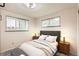 Comfortable bedroom with two windows, tufted headboard, bench, and neutral decor at 798 Alkire St, Lakewood, CO 80401
