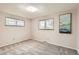 Neutral bedroom offers natural light with two windows and neutral walls and carpet at 798 Alkire St, Lakewood, CO 80401