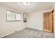 Bright bedroom with large window, neutral paint, and carpet, providing a cozy atmosphere at 798 Alkire St, Lakewood, CO 80401