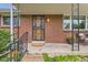 Inviting front porch with decorative ironwork, brick facade, and a cozy seating area at 798 Alkire St, Lakewood, CO 80401