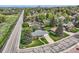 Aerial view of a well-maintained home with a green lawn, mature trees and a long driveway at 798 Alkire St, Lakewood, CO 80401
