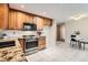 Charming kitchen featuring tile floors, wooden cabinets, stainless steel appliances, and granite countertops at 798 Alkire St, Lakewood, CO 80401