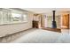 Spacious living room featuring a decorative fireplace, and large window for natural lighting at 798 Alkire St, Lakewood, CO 80401