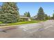 Brick home on a well-maintained street with mature trees and landscaping, showcasing neighborhood charm at 798 Alkire St, Lakewood, CO 80401
