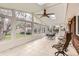Bright sunroom with tiled floor, ceiling fan, skylight, and many windows at 798 Alkire St, Lakewood, CO 80401