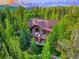 Aerial view of home surrounded by trees, featuring decks and outdoor space at 41 Stillson Placer Ter, Breckenridge, CO 80424