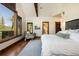 Airy bedroom with hardwood floors, beam ceilings, barn door, and mountain views from the window at 41 Stillson Placer Ter, Breckenridge, CO 80424