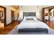Beautiful bedroom features hardwood floors, a gray upholstered headboard, and modern bedside lighting at 41 Stillson Placer Ter, Breckenridge, CO 80424
