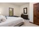 Bright bedroom featuring a comfortable bed, dresser, mirror, and wooden accents at 41 Stillson Placer Ter, Breckenridge, CO 80424