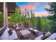 Outdoor deck area with mountain views, features lounge seating and a dining area, perfect for entertaining at 41 Stillson Placer Ter, Breckenridge, CO 80424