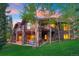 Exterior of a home with multiple terraces, hot tub, and well-manicured lawn at 41 Stillson Placer Ter, Breckenridge, CO 80424