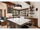 Gourmet kitchen with island, stainless steel appliances, seating, and large windows with backyard views at 41 Stillson Placer Ter, Breckenridge, CO 80424