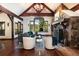 Open living room featuring vaulted ceilings, wood beams, and a stone fireplace at 41 Stillson Placer Ter, Breckenridge, CO 80424