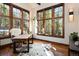 Bright office features hardwood floors, oversized windows with natural light, and stylish desk and decor at 41 Stillson Placer Ter, Breckenridge, CO 80424