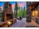 Outdoor grill and stone fireplace with seating area at 41 Stillson Placer Ter, Breckenridge, CO 80424