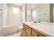 An efficient bathroom has a shower over the bath and a modern vanity at 14211 E 1St Dr # 308, Aurora, CO 80011