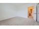 A bedroom showcasing the ensuite bathroom with a light paint, neutral carpet, and an open doorway at 14211 E 1St Dr # 308, Aurora, CO 80011