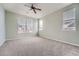 Minimalist bedroom with neutral walls, carpet, and two windows with blinds at 14211 E 1St Dr # 308, Aurora, CO 80011