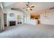 Bright living room features vaulted ceilings, neutral paint, carpet, and a modern fireplace at 14211 E 1St Dr # 308, Aurora, CO 80011