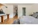 Bright bedroom featuring light wood floors and an ensuite bathroom at 900 Locust St, Denver, CO 80220