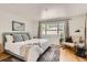 Bright bedroom featuring a patterned rug, soft natural light, and a sitting area at 900 Locust St, Denver, CO 80220