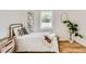 Bedroom featuring a full sized bed and light wood floors at 900 Locust St, Denver, CO 80220