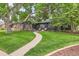 Charming home with a well-maintained lawn and a stone pathway leading to the front door at 900 Locust St, Denver, CO 80220
