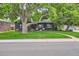 Exterior front elevation of the house with lovely landscaping and mature trees at 900 Locust St, Denver, CO 80220