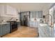 Modern kitchen with shaker cabinets, marble countertops, stainless steel appliances, and hardwood floors at 900 Locust St, Denver, CO 80220