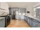 Modern kitchen with shaker cabinets, stainless steel appliances, marble countertops, and hardwood floors at 900 Locust St, Denver, CO 80220