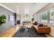 Open concept living room boasting hardwood floors, a gray accent wall, and contemporary furnishings at 900 Locust St, Denver, CO 80220