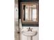 Classic bathroom vanity with a decorative mirror and updated fixtures at 2741 Sunset Way, Erie, CO 80516