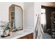 Bathroom vanity with decorative accents, a modern faucet, and a glimpse into a well-appointed bedroom at 2741 Sunset Way, Erie, CO 80516