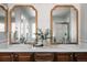 Elegant bathroom featuring double sinks, wooden cabinets, stylish mirrors, and contemporary design elements at 2741 Sunset Way, Erie, CO 80516