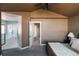 Spacious bedroom with an ensuite bathroom view, showcasing a bathtub and modern interior design at 2741 Sunset Way, Erie, CO 80516