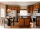 Kitchen featuring wood floors, stainless steel appliances, wood cabinets, and a kitchen island at 2741 Sunset Way, Erie, CO 80516