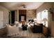 Sunlit living room featuring a stone fireplace, built-in cabinets, and comfortable seating at 2741 Sunset Way, Erie, CO 80516