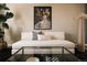 Comfortable living room featuring a white sofa, glass coffee table, and decorative art at 2741 Sunset Way, Erie, CO 80516